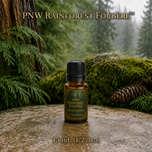 PNW Rainforest Fougère perfume concentrate sample vial with yellow liquid on a pale rock in a wet Pacific Northwest evergreen forest - 15ml glass bottle