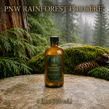 PNW Rainforest Fougère perfume concentrate sample vial with yellow liquid on a pale rock in a wet Pacific Northwest evergreen forest - 4oz glass bottle
