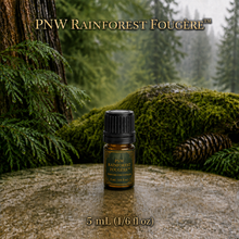 PNW Rainforest Fougère perfume concentrate sample vial with yellow liquid on a pale rock in a wet Pacific Northwest evergreen forest - 5ml glass bottle