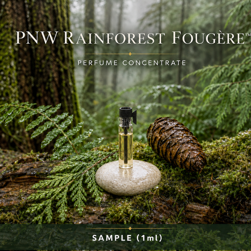 1 mL PNW Rainforest Fougère perfume concentrate sample vial with yellow liquid on a pale rock in a wet Pacific Northwest evergreen forest
